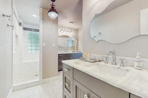 a bathroom with a large sink and a shower at Opulent Waterfront Home with Dock, Firepit & Stunning River View in Burnet