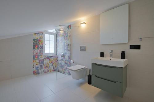 a bathroom with a toilet and a sink and a shower at Villa Ahad in Fethiye