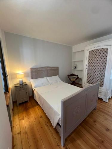 a bedroom with a large bed and a window at Cà Dal Vindu in Biella