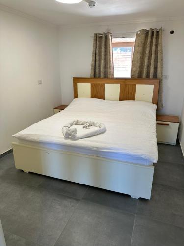 a bedroom with a bed with a dummy on it at carmel cabins suite nu 10 in Haifa
