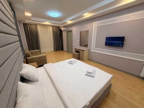a hotel room with a bed and a flat screen tv at Bea Paradise 113 in Baku