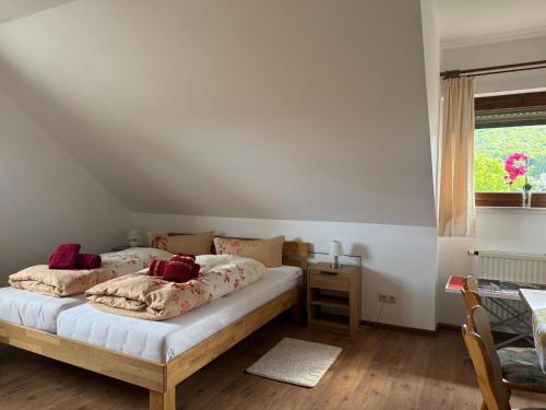 a bedroom with two beds and a window at Ferienwohnung mit großem Balkon und Blick in den Taunus in Oberems