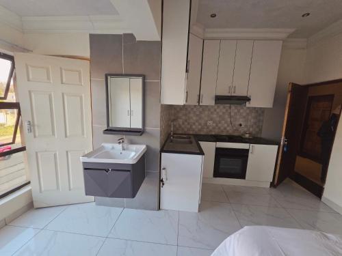 a kitchen with a sink and a counter top at Mafjoint10 in eMalahleni