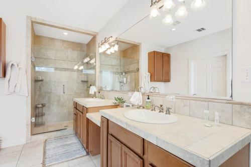 a bathroom with a sink and a large mirror at Natural Cliffside Oasis with Impressive Views, Gas Fireplace and Dock in Spicewood