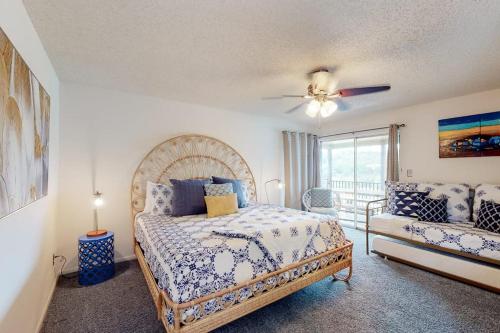 a bedroom with a bed and a couch at Mid-Century Modern Lake House with Private Waterfront Pool & Boat Dock in Marble Falls
