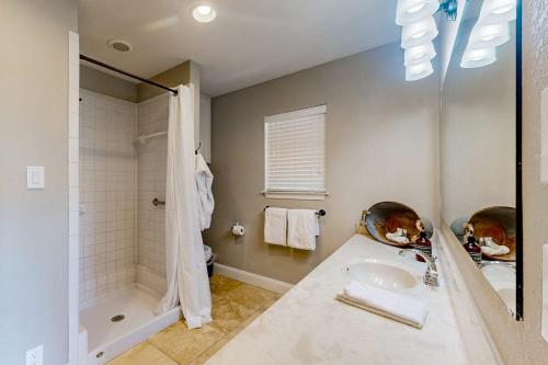 a bathroom with a tub and a sink and a shower at Spacious Lakefront Hideaway with Decks, Grill, Billiards, Tennis & Pool in Spicewood