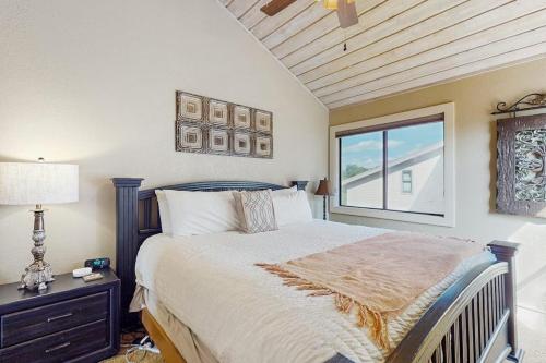 a bedroom with a large bed and a window at Refined Panoramic Paradise on Lake Travis with Boat Launch and Tesla Charger in Spicewood