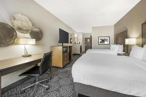 a hotel room with a large bed and a desk at Best Western Plus Spokane North in Spokane