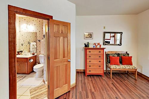 a bathroom with a toilet and a sink and a mirror at Regal Riverfront Home with 2 Cabins - 2 Miles to Marina in Spicewood