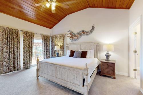 a bedroom with a large bed and a wooden ceiling at Regal Riverfront Home with 2 Cabins - 2 Miles to Marina in Spicewood
