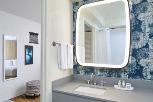 a bathroom with a sink and a mirror at Waikiki Malia in Honolulu