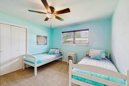 a bedroom with two beds and a ceiling fan at Waterfront Home with Kayaks, Game Room, Firepit, & Enormous Deck in Kingsland