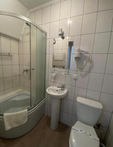 a bathroom with a toilet and a sink and a shower at Svit home Hamster 007- apart-hotel in Lviv