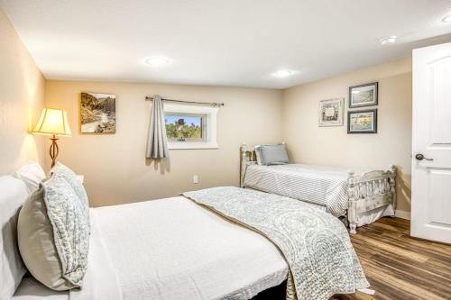 a bedroom with two beds and a window at Expansive Getaway Near Downtown with Fast WiFi, Grill in Fredericksburg