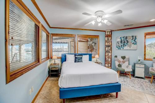 a bedroom with a bed and a ceiling fan at Stunning Lakefront Home with 2 Patios, Chef's Kitchen, & Lake Access in Spicewood