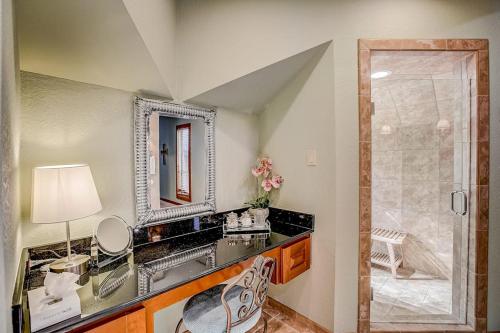 a bathroom with a sink and a mirror and a shower at Stunning Lakefront Home with 2 Patios, Chef's Kitchen, & Lake Access in Spicewood