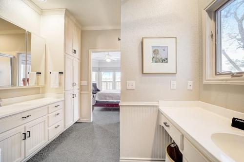 a white bathroom with a sink and a mirror at Lakeside, Dog-Friendly Living with Kayaks, Boat Ramp, Pool Table & Ping-Pong in Kingsland