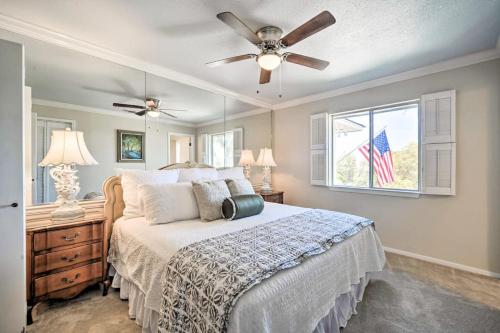 a bedroom with a bed with a ceiling fan and a window at Snowbird-Friendly House with Game Room, Full Kitchen, Balcony & W/D in Kerrville