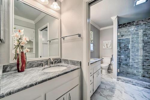 a bathroom with a sink and a toilet and a mirror at Snowbird-Friendly House with Game Room, Full Kitchen, Balcony & W/D in Kerrville