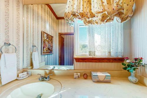 a bathroom with a sink and a large mirror at 2-Story Home with Covered Patio, Balcony, Fireplace, Streaming, Great Views, W/D in Kerrville