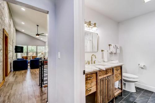 a white bathroom with a sink and a toilet at Downtown 2-Story Home with Enclosed Backyard, Patio, Pool, Playground, W/D, AC in Fredericksburg