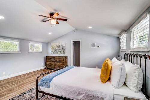 a bedroom with a bed and a ceiling fan at Downtown 2-Story Home with Enclosed Backyard, Patio, Pool, Playground, W/D, AC in Fredericksburg