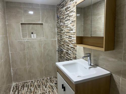 a bathroom with a sink and a mirror at Santa Barbara River house in Santo Domingo
