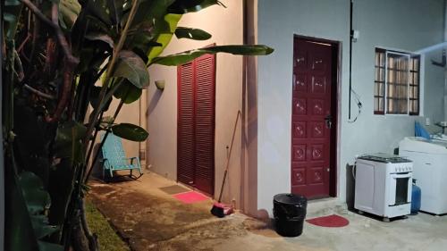 a room with a door and a plant next to a house at Microcasa Pousada Residencial Botânica com Kit Café da manhã in Itupeva