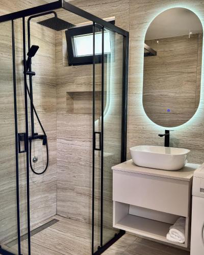 a bathroom with a sink and a mirror at RiverHouse Tošinović in Šipovo