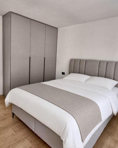 a bedroom with a large bed with white sheets at RiverHouse Tošinović in Šipovo