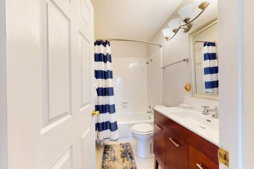 a bathroom with a sink and a toilet and a shower at Lovely 2-Story Home with Upper & Lower Decks, Gorgeous Lake & Hill Country Views in Burnet