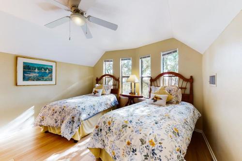 a bedroom with two beds and a ceiling fan at Lovely 2-Story Home with Upper & Lower Decks, Gorgeous Lake & Hill Country Views in Burnet