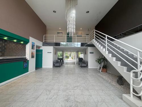 an empty lobby with a staircase in a building at Seaside Garden Hotel in Wamberal