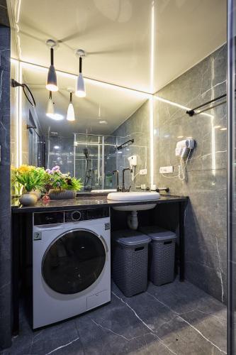 a bathroom with a washing machine and a sink at 4Season Villa in Tbilisi City