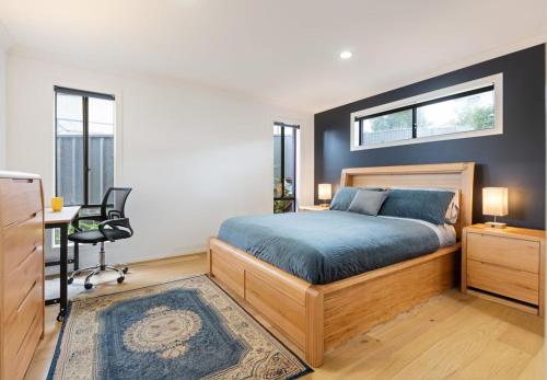 a bedroom with a bed and a desk and a window at Marlin Vista - Pet Friendly in Eden