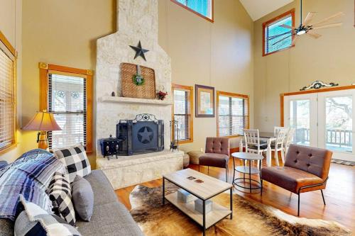 a living room with a couch and a fireplace at Peaceful Home with Fire Pit, Gazebo, Patio, & Amazing Deck Views - Dog-Friendly in Fredericksburg