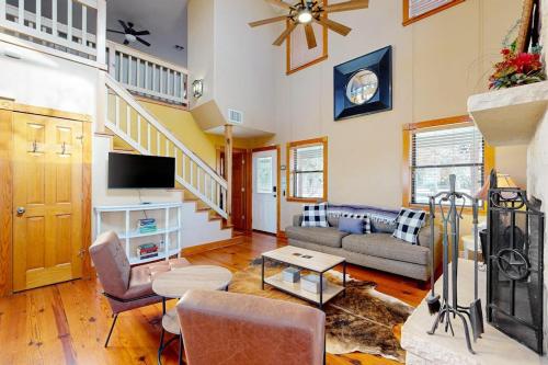 a living room with a couch and a tv at Peaceful Home with Fire Pit, Gazebo, Patio, & Amazing Deck Views - Dog-Friendly in Fredericksburg