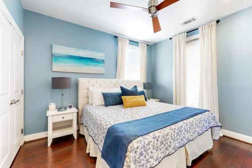 a blue bedroom with a bed and a ceiling fan at Water-View Condo with Balcony, Smart TVs, Washer/Dryer and Pool in Horseshoe Bay