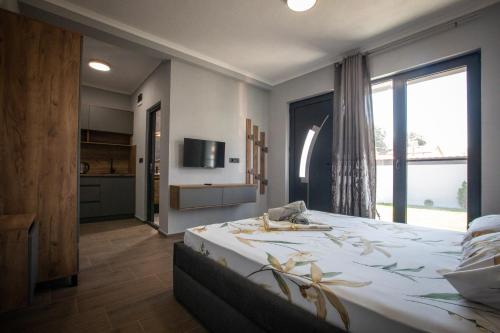 a bedroom with a large bed and a large window at Sofia Luxury Apartments in Gevgelija