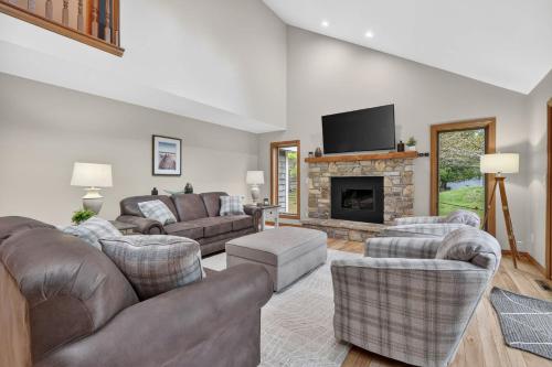 a living room with couches and a fireplace at Cottage on the Hill in Ephraim