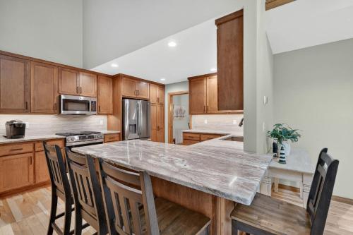 a kitchen with wooden cabinets and a large marble counter top at Cottage on the Hill in Ephraim