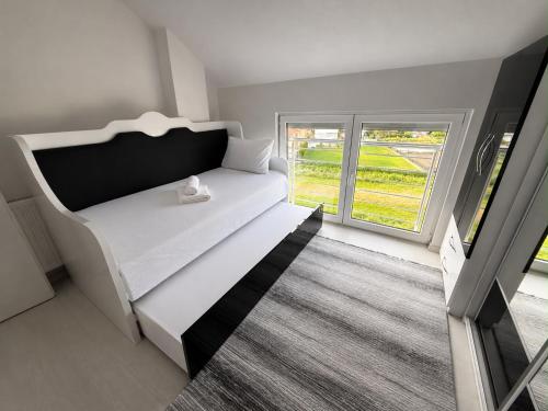 a bedroom with a bed and a large window at Serenity Apartment in Struga