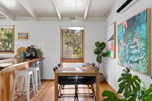a kitchen with a table and chairs in a room at A charming escape from everyday life in Aireys Inlet
