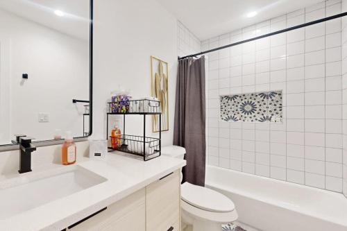 a bathroom with a sink and a toilet and a tub at Modern Lago Vista Home with Balcony, Patio, Gas Grill, WIFI, and AC in Lago Vista