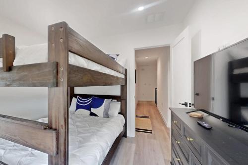 a bedroom with a bunk bed and a television at Modern Lago Vista Home with Balcony, Patio, Gas Grill, WIFI, and AC in Lago Vista