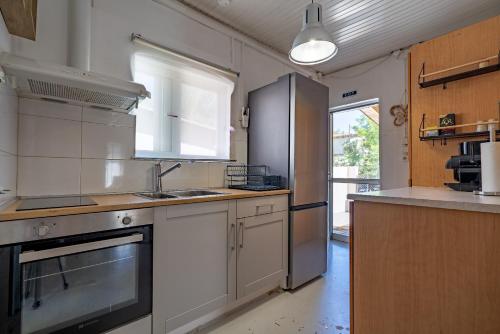 a kitchen with a sink and a stove at Chill Coast House in Nisís Áyios Nikólaos