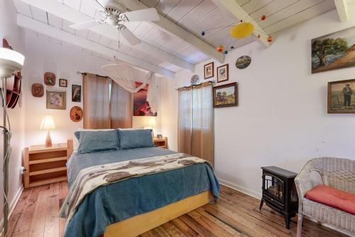 a bedroom with a large bed and a chair at Cozy Dog-Friendly House Near Water with Enclosed Yard, Grill, & Equipped Kitchen in Burnet