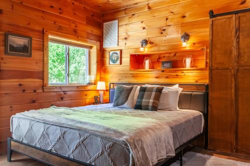 a bedroom with a bed in a wooden cabin at Edge View Chalet in Bryson City