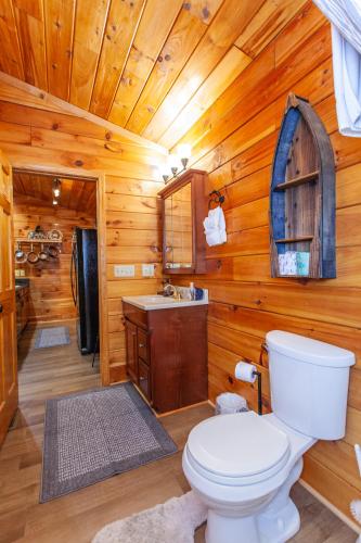a bathroom with a toilet and a sink in a cabin at Edge View Chalet in Bryson City