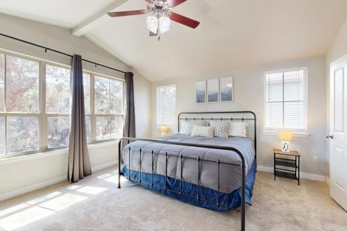 a bedroom with a bed and a ceiling fan at Cozy Lago Vista Home with Private Pool Table, Mile From The Stunning Lake Travis in Lago Vista